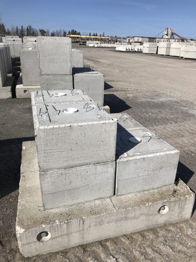 Stacked concrete blocks with metal rings.