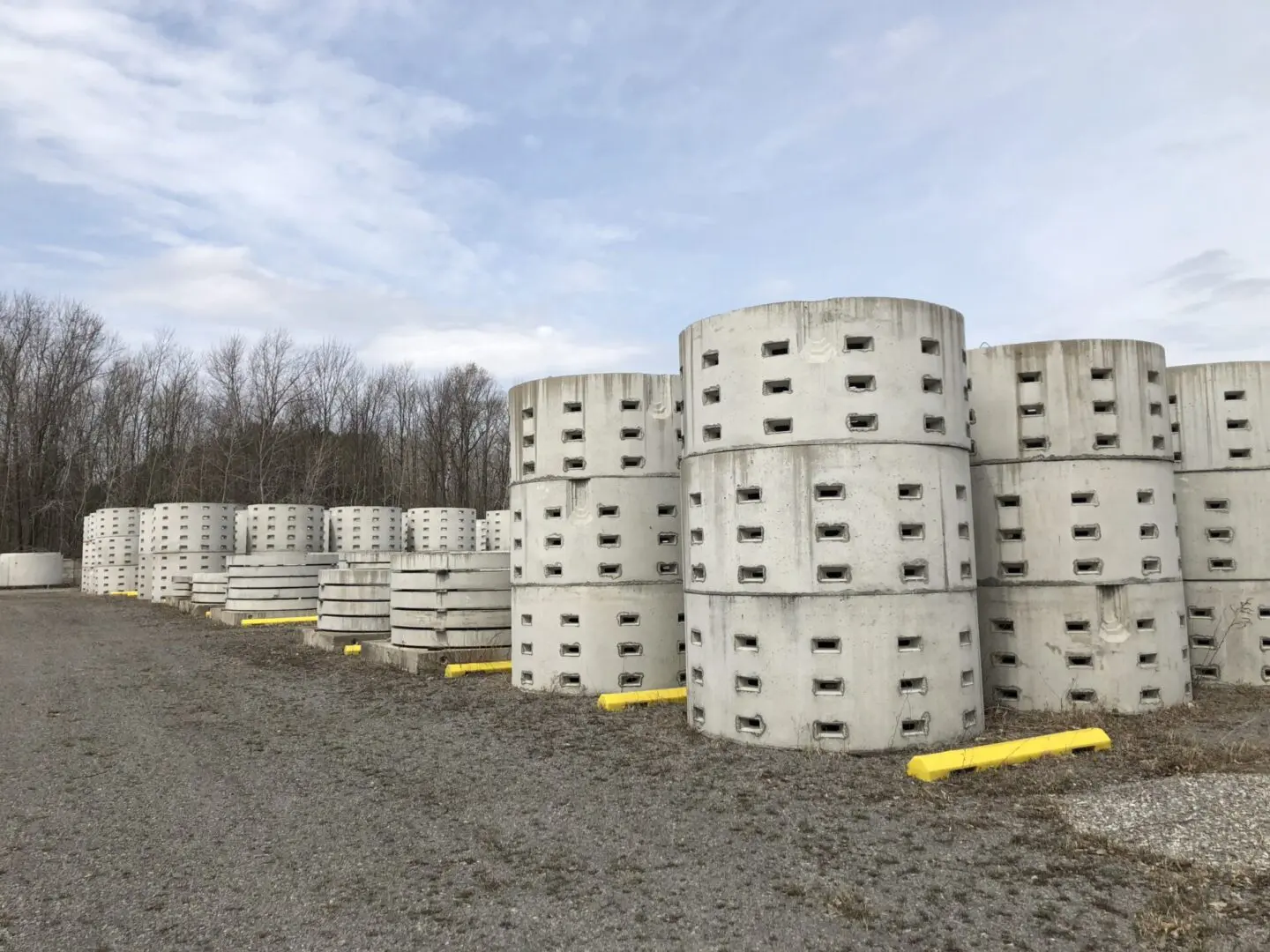 Concrete drainage pipes stacked outdoors.