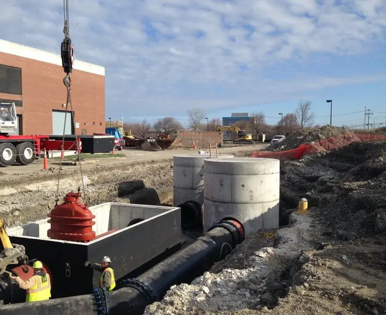 A red fire hydrant sitting on top of cement.